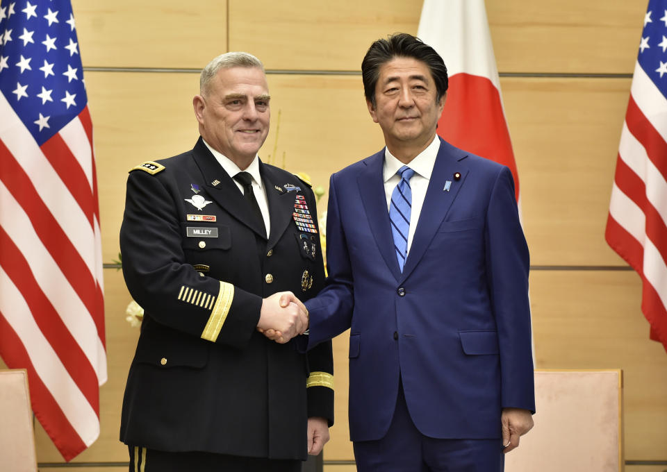 Japan's Prime Minister Shinzo Abe, right, shakes hands with U.S. Chairman of the Joint Chiefs of Staff Gen. Mark Milley, left, prior to their talks at the Abe's office in Tokyo Tuesday, Nov. 12, 2019. (Kazuhiro Nogi/Pool Photo via AP)