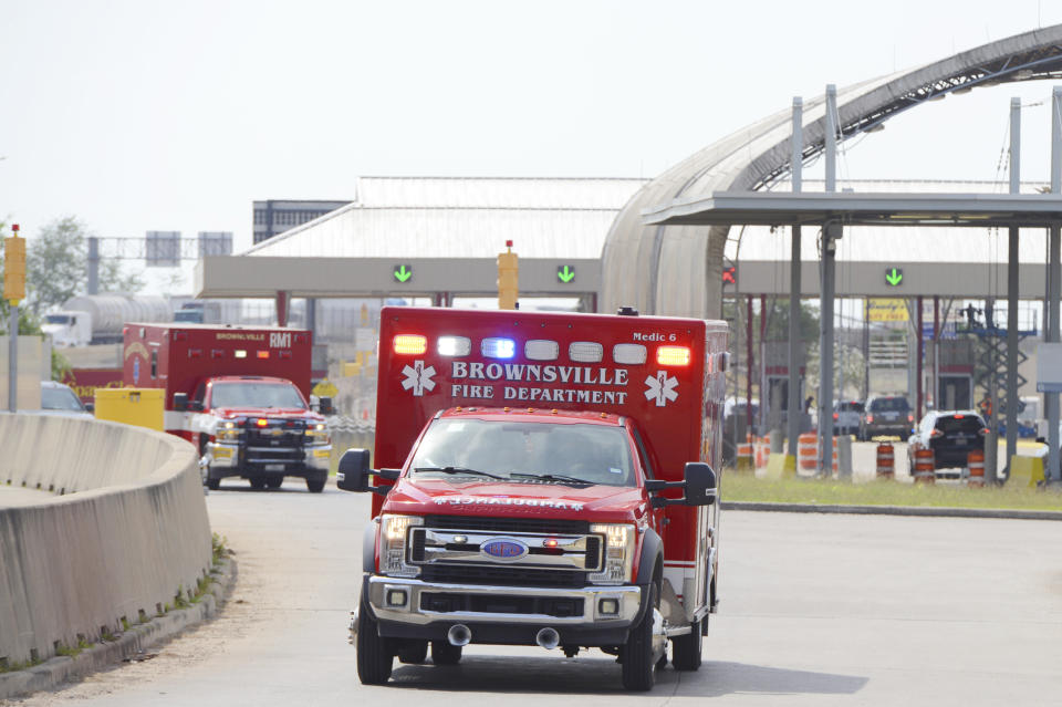 Brownsville Fire Department EMS Ambulances drive through Veterans International Bridge at Los Tomates with two surviving U.S. citizens being transported to Valley Regional Medical Center, Tuesday, March 7, 2023, in Brownsville, Texas, after having been kidnapped and shot at by gunmen in Matamoros, Mexico. The March 3 shooting left two other Americans dead. (Miguel Roberts/The Brownsville Herald via AP)