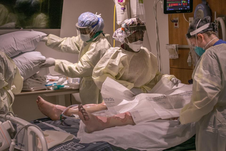 A "prone team" prepares to turn a COVID-19 patient onto his stomach.