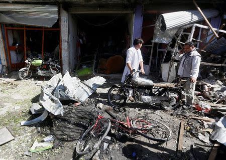 Afghan shopkeepers collect reamains in front of a shop after a suicide attack in Kabul, Afghanistan. July 24, 2017.REUTERS/Omar Sobhani