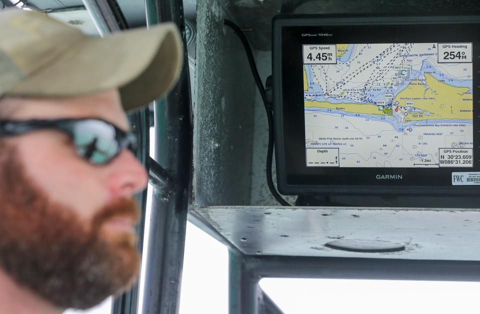 Florida Fish and Wildlife Conservation Commission Lt. Jarrod Molnar looks across his boat with a marine map display in the background. The FWC, Okaloosa County Sheriff's Office and Coast Guard will be out in force this weekend to enforce boating laws.