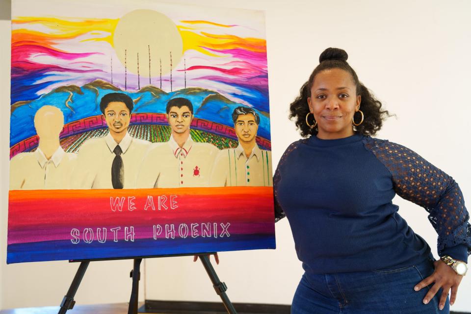 Therosia Reynolds poses for a portrait with a rough first iteration of her public art piece at Mesa Artspace Lofts on Dec. 9, 2022, in Mesa, Ariz. Reynolds' mural will be displayed at a Traction Power Substation along Carter Road in Phoenix and will depict five notable South Phoenix leaders, flower fields, South Mountain, and an original poem.