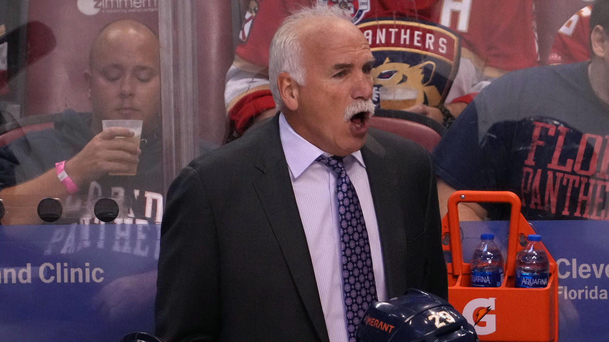 Colorado Avalanche head coach Joel Quenneville (R) wears his old