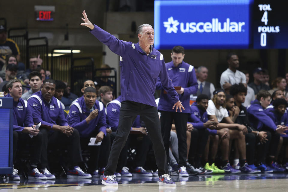 TCU coach Jamie Dixon gestures during the first half of the team's NCAA college basketball game against West Virginia on Wednesday, Jan. 18, 2023, in Morgantown, W.Va. (AP Photo/Kathleen Batten)