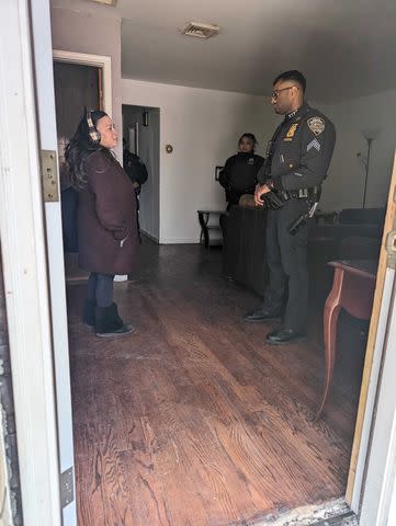 <p>Angela Andaloro</p> Adele Andaloro and NYPD officers in her late parents' home in Queens