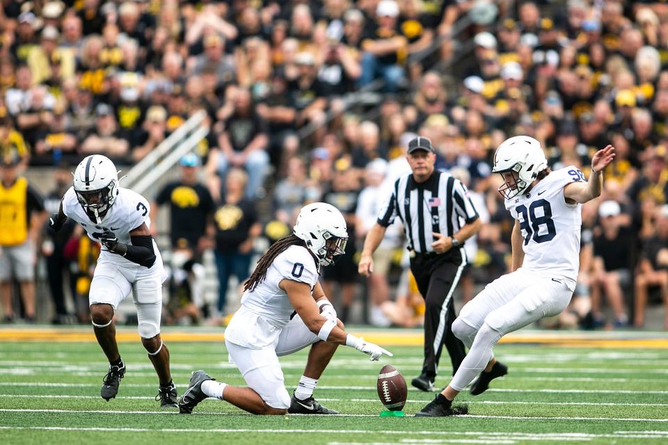 Penn State's Jordan Stout (98) kicks off as Penn State safety Jonathan Sutherland (0) holds the ball on the tee during a NCAA Big Ten Conference football game against Iowa, Saturday, Oct. 9, 2021, at Kinnick Stadium in Iowa City, Iowa. Iowa beat Penn State, 23-20.