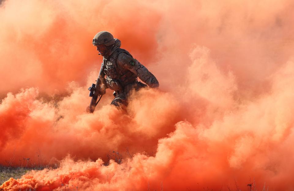 A soldier of the United Kingdom's 2nd Battalion Royal Anglian infantry storms an enemy position in a simulated attack during the NATO "Brilliant Jump" military exercises on February 26, 2024 in Drawsko Pomorskie, Poland.