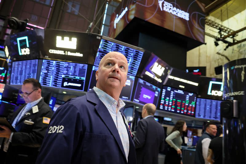 FILE PHOTO: Traders work on the floor of the NYSE in New York