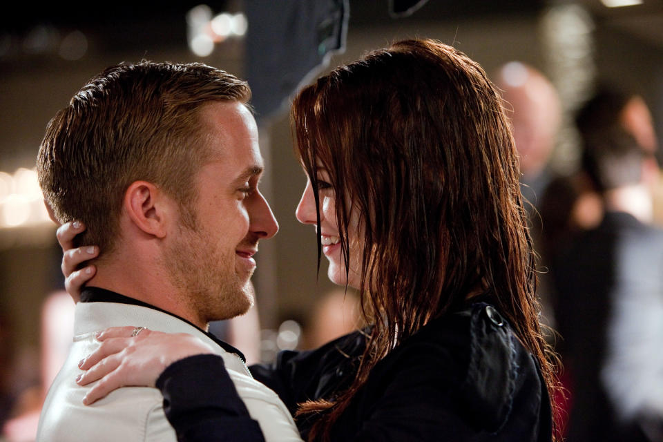 Ryan Gosling and Emma Stone, wet from the rain, holding each other