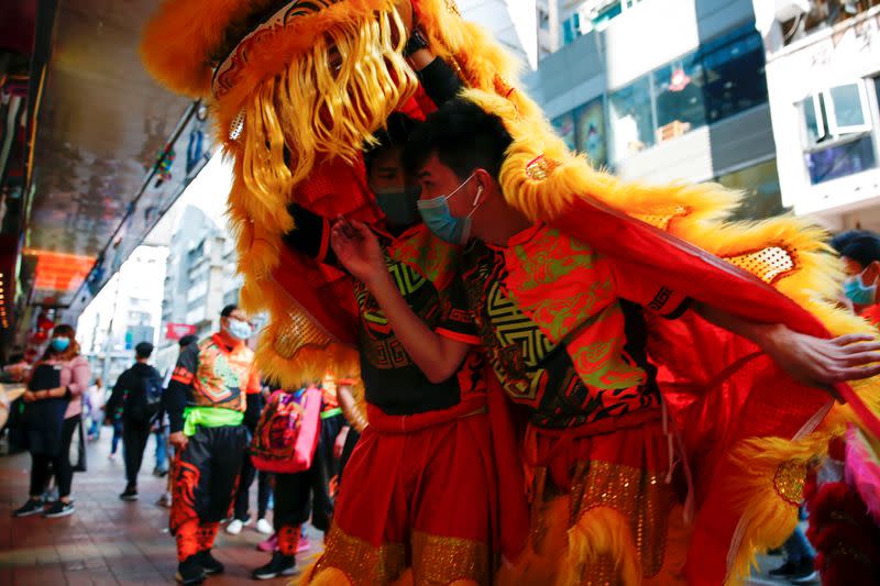 Performers wear masks to prevent an outbreak of a coronavirus as they perform a traditional Chinese lion dance to mark the Chinese Lunar New Year, in Hong Kong