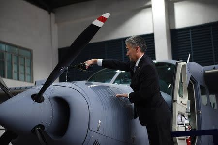 U.S. Ambassador to the Philippines Sung Kim pours wine on a Cessna-208B Grand Caravan Intelligence, Surveillance and Reconnaissance (ISR) aircraft acquired by the Philippine government from the U.S. during a turn over ceremony at the Philippine Air Force (PAF) headquarters in Manila, Philippines July 27, 2017. REUTERS/Dondi Tawatao