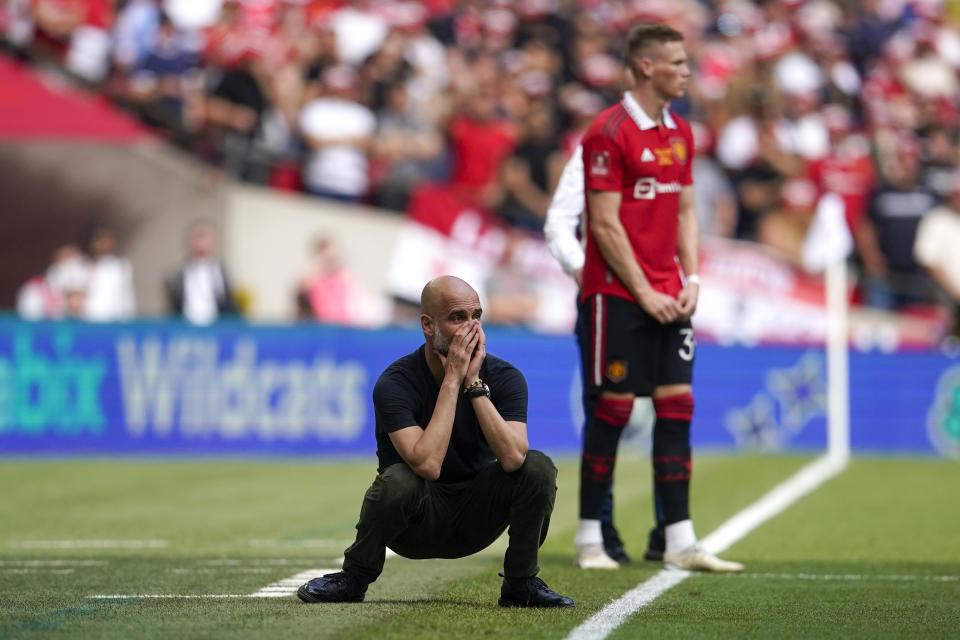 Manchester City's head coach Pep Guardiola gestures during the English FA Cup final soccer match between Manchester City and Manchester United at Wembley Stadium in London, Saturday, June 3, 2023. (AP Photo/Dave Thompson)