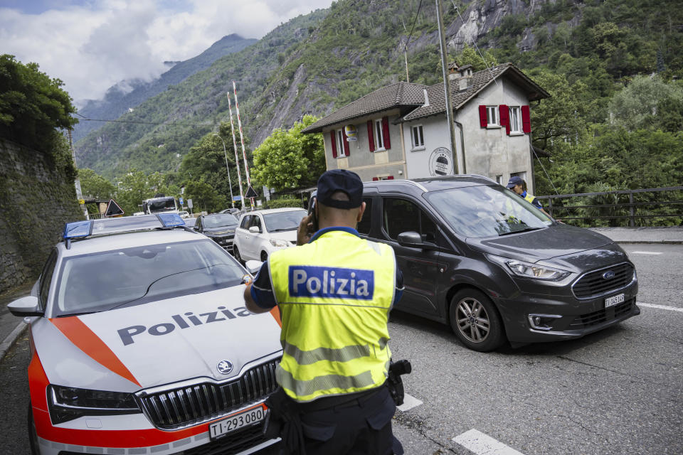 Police blockade for non-residents in the area at Ponte Brolla, Sunday, June 30, 2024. Following the landslide in the Maggia Valley, rescuers recovered two bodies on Sunday. One person is still missing, according to the Ticino cantonal police in Valle Maggia, Switzerland, Sunday, June 30, 2024. (Pablo Gianinazzi/Keystone via AP)