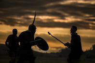 Participants in the Romula Fest reenact Roman Empire era gladiator fights in the village of Resca, Romania, Saturday, Sept. 3, 2022. (AP Photo/Andreea Alexandru)