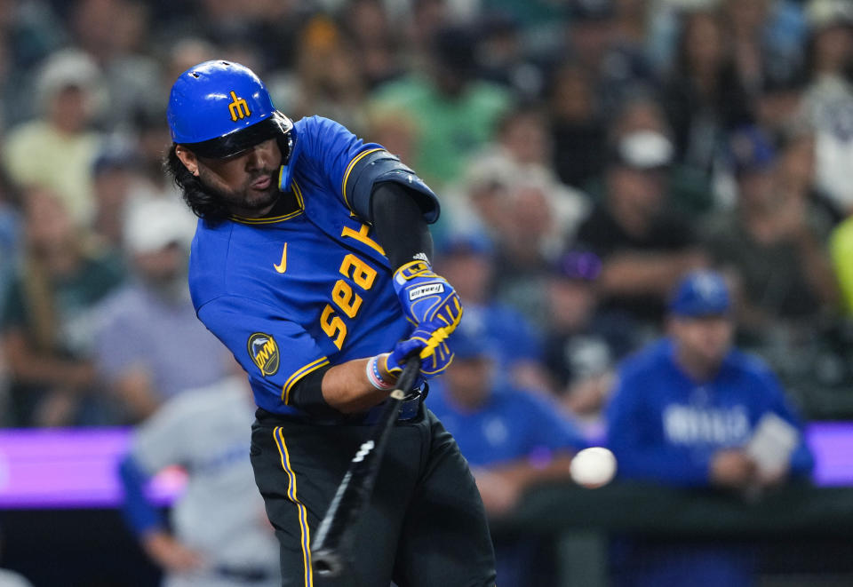 Seattle Mariners' Eugenio Suárez hits an RBI double against the Kansas City Royals during the eighth inning of a baseball game Friday, Aug. 25, 2023, in Seattle. (AP Photo/Lindsey Wasson)