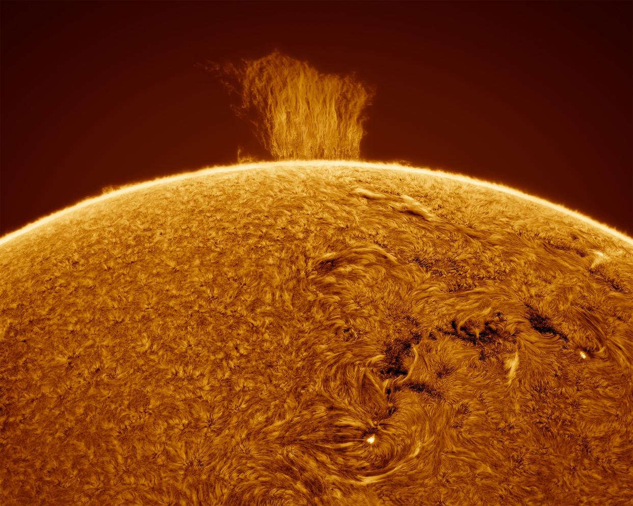 A picture of the sun shows a square prominence sticking out of the sun like a waterfall