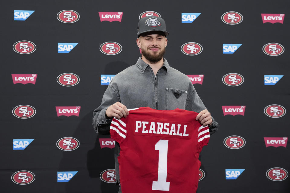 San Francisco 49ers first-round draft pick Ricky Pearsall Jr. holds a jersey during an NFL press conference, Friday, April 26, 2024, at the team's facility in Santa Clara, Calif. (AP Photo/Godofredo A. Vásquez)