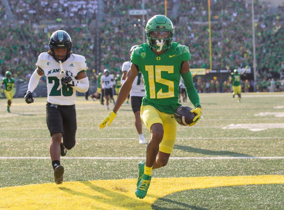 Oregon's Tez Johnson, center, runs into the end zone for the first score of the game against Hawaii during the first half in Eugene on Sept. 16.