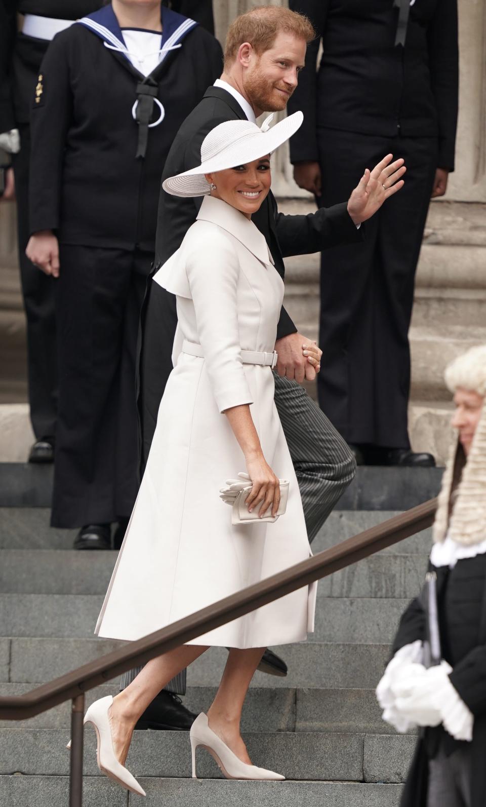 Prince Harry and Meghan Markle walking up the steps of St Paul's Cathedral.