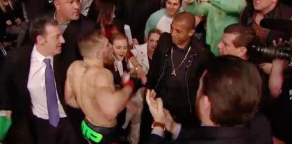 Jose Aldo (in black) has to deal with Conor McGregor's antics for four more months. (MMAWeekly)