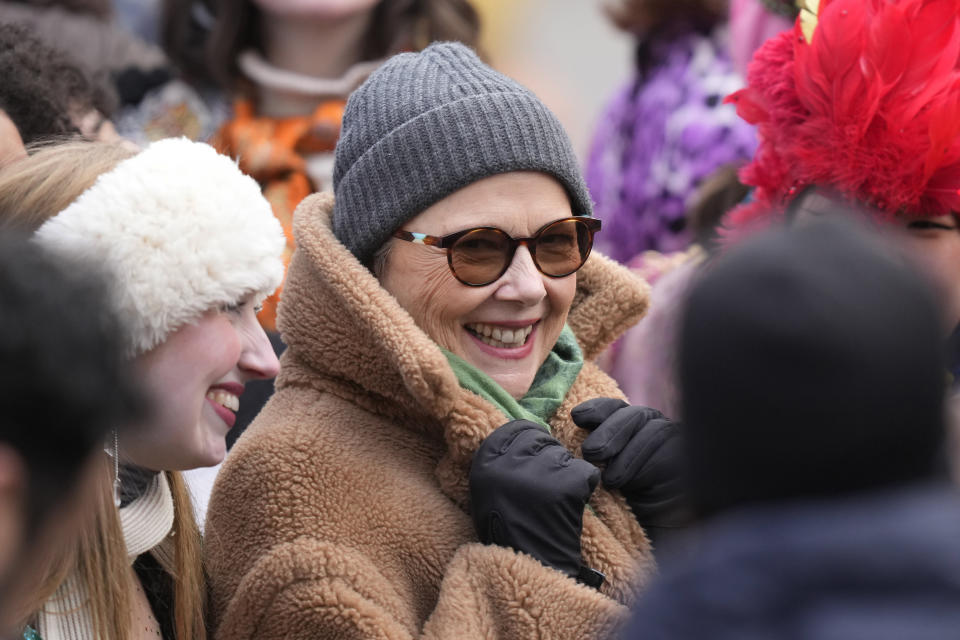 Actor Annette Bening, center, Hasty Pudding 2024 Woman of the Year, speaks with Harvard University theatrical students before a parade, Tuesday, Feb. 6, 2024, through Harvard Yard, in Cambridge, Mass. The award was presented to Bening by Hasty Pudding Theatricals, a theatrical student society at Harvard University. (AP Photo/Steven Senne)