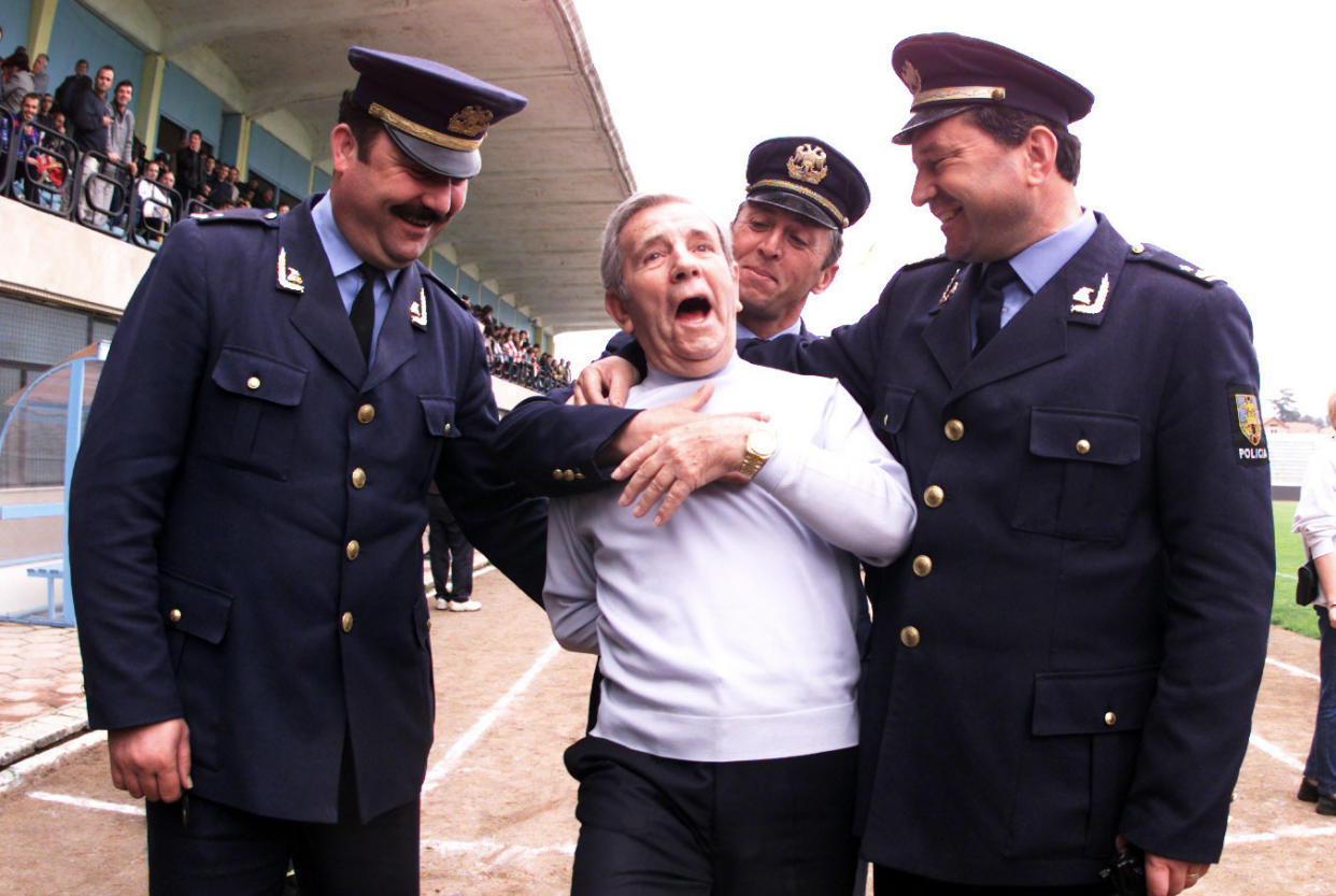 Norman Wisdom entertains the local police while England train in Albania, 2001 (Andy Hooper/Daily Mail/REX/Shutterstock)