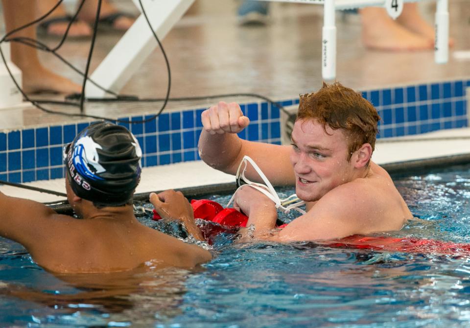 Gainesville's Michael Mullen, right, shown celebrating his win in the 200 IM at the 3A Region 1 championships last week in Ocala, is seeded first in the event at the state meet.