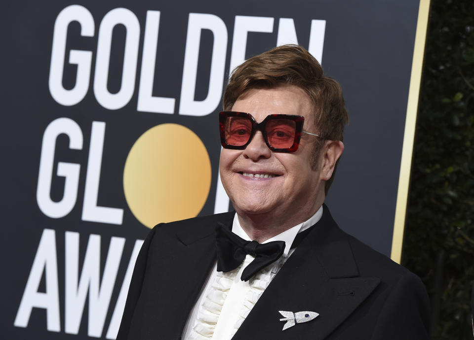 FILE - In this Jan. 5, 2020 file photo, Elton John arrives at the 77th annual Golden Globe Awards at the Beverly Hilton Hotel, in Beverly Hills, Calif. An emotional John had to cut short a performance in New Zealand on Sunday, Feb. 16 after he lost his voice due to walking pneumonia and had to be assisted off stage. John reached out to his fans on Instagram on Sunday, apologizing for ending his show at Auckland's Mt Smart Stadium early. (Photo by Jordan Strauss/Invision/AP, File)