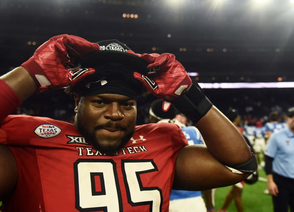 Texas Tech defensive tackle Jaylon Hutchings (95) dons a Texas Bowl champions hat after the Red Raiders' 42-25 victory Wednesday night in Houston against Mississippi.