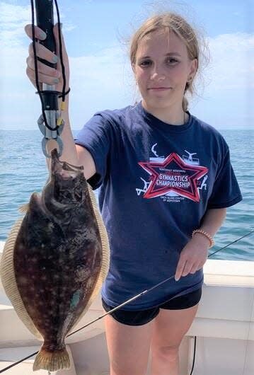 Phoebe Turner of Cumberland with a fluke, or summer flounder, she caught last week when fishing with her father, Keith.