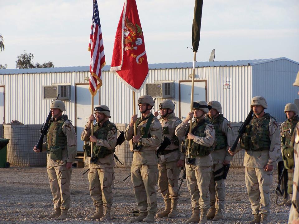 A Soldier from the 612th Engineer Battalion holds the battalion colors during a transfer of authority ceremony with units of the 1st Cavalry Division on Feb. 5, 2005, in Iraq.