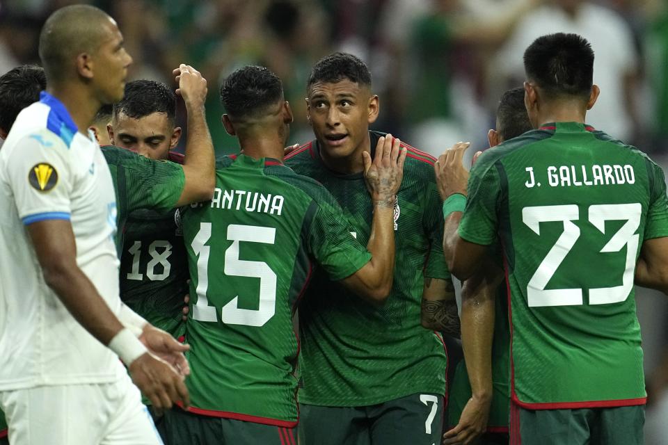 Mexico's Luis Romo (7) celebrates with teammates after scoring a goal against Honduras during the first half of a CONCACAF Gold Cup soccer match Sunday, June 25, 2023, in Houston. (AP Photo/David J. Phillip)