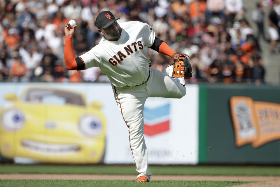 FILE - In this July 21, 2019, file photo, San Francisco Giants third baseman Pablo Sandoval throws to first base on an infield hit by New York Mets' Todd Frazier during the 12th inning of a baseball game in San Francisco. The 33-year-old Sandoval is working back from season-ending Tommy John reconstructive surgery on his right elbow. (AP Photo/Jeff Chiu, File)