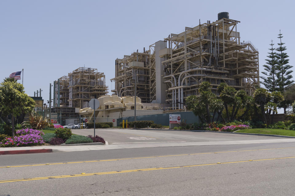 This May 2, 2022, photo shows the AES Huntington Beach Energy Center in Huntington Beach, Calif. The entrance to the AES facility, the proposed site of the Poseidon Huntington Beach Seawater Desalination Plant will face a critical vote by the California Coastal Commission (CCC) on Thursday, May 12. The highly contested project has been debated for more than two decades. (AP Photo/Damian Dovarganes)