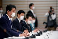 Japan's Prime Minister Shinzo Abe speaks during a meeting about the measures against the coronavirus disease (COVID-19), at the prime minister official residence in Tokyo