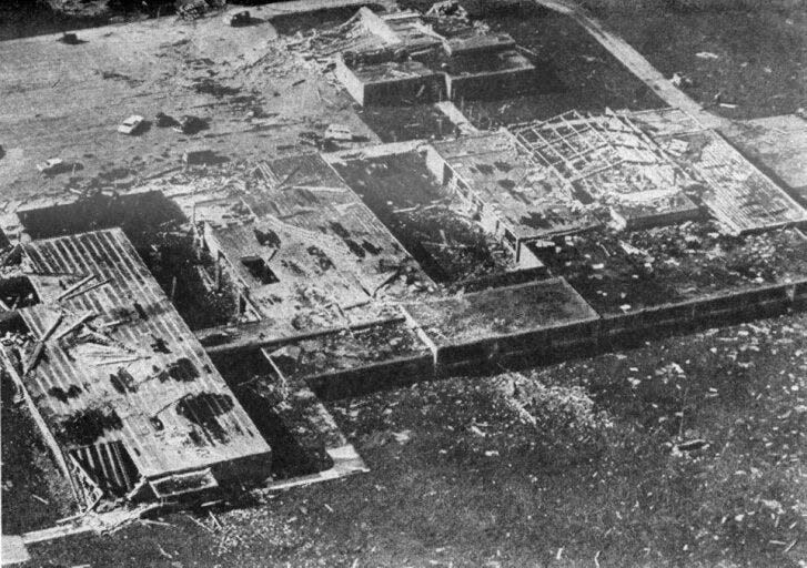 This aerial view of Monroe Central School offers an appraisal of the destructive power of the tornado which slashed across western Randolph County on April 3, 1974. The stick-like objects atop sections of the school are actually steel-reinforced concrete beams, weighing up to 2,000 pounds, which were ripped from the structure and tossed around by the wind.