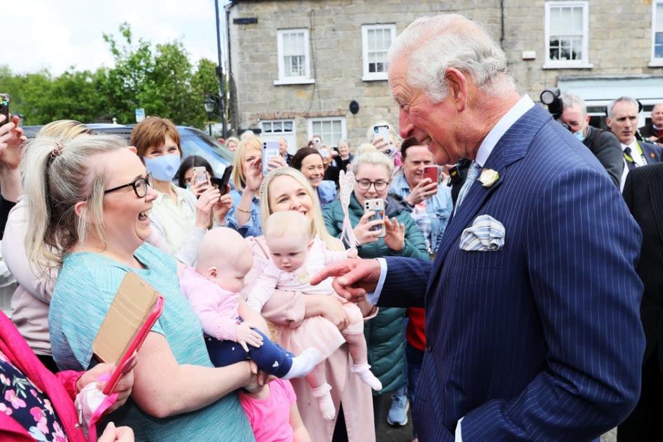 The Prince of Wales met Nicola Morton and her four-month-old daughter Evie (left) and Cathryn Grant and her seven-month-old daughter Sophia, during his visit to Caledon village in May (Brain Lawless/PA) (PA Archive)