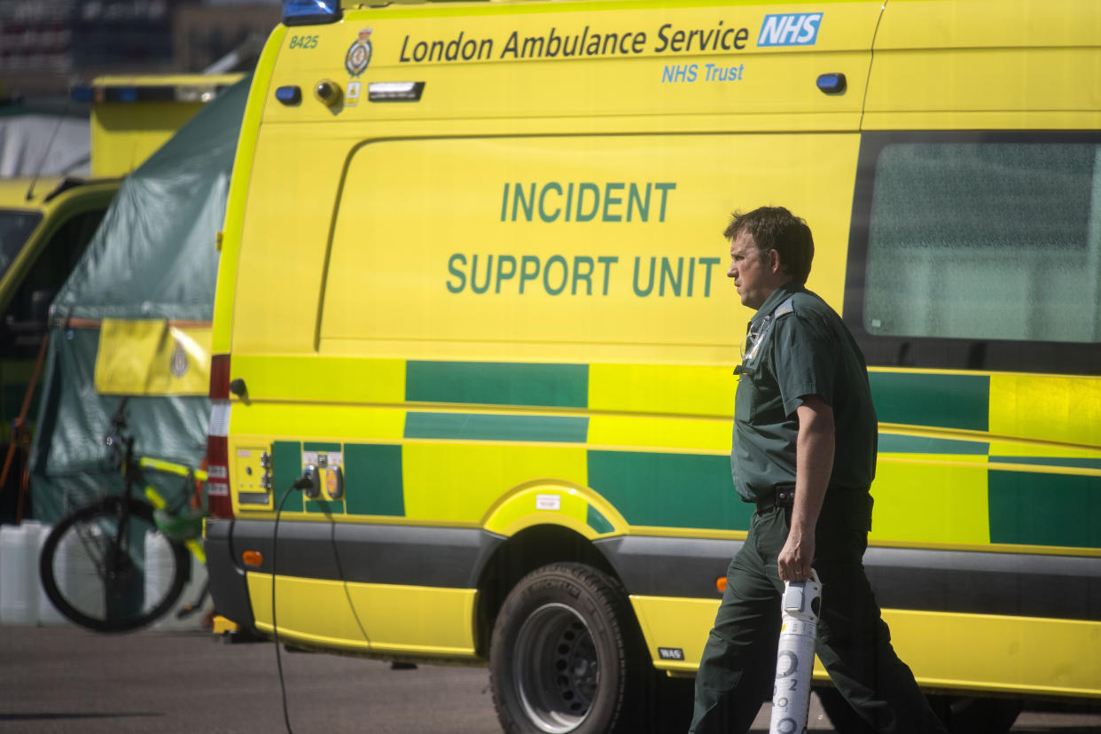 NHS workers prepare a line of ambulances outside at the NHS Nightingale Hospital at the Excel Centre in London as the UK continues in lockdown to help curb the spread of the coronavirus.