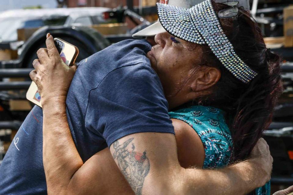 <p>Robert Gauthier/Los Angeles Times via Getty </p> Melissah Shishido hugs a donor while gathering supplies at Costco for Lahaina residents on Kahului Maui, Monday, August 14, 2023.