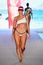 <p>A model walks the runway wearing a patriotic-style sporty bikini set and visor for the 2018 <em>Sports Illustrated</em> swimsuit show during Miami Swim Week at the W South Beach hotel on July 15. (Photo: Alexander Tamargo/Getty Images for Sports Illustrated) </p>