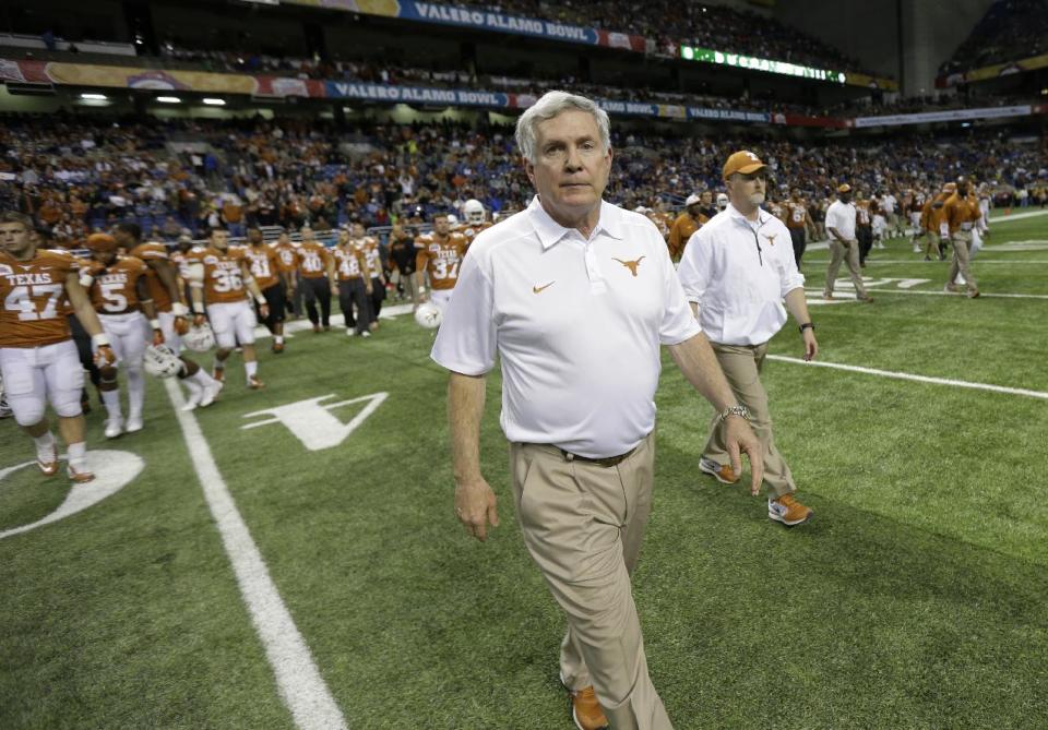 Texas coach Mack Brown walks onto the field following the Valero Alamo Bowl NCAA college football game against Oregon, Monday, Dec. 30, 2013, in San Antonio. Oregon won 30-7. (AP Photo/Eric Gay)