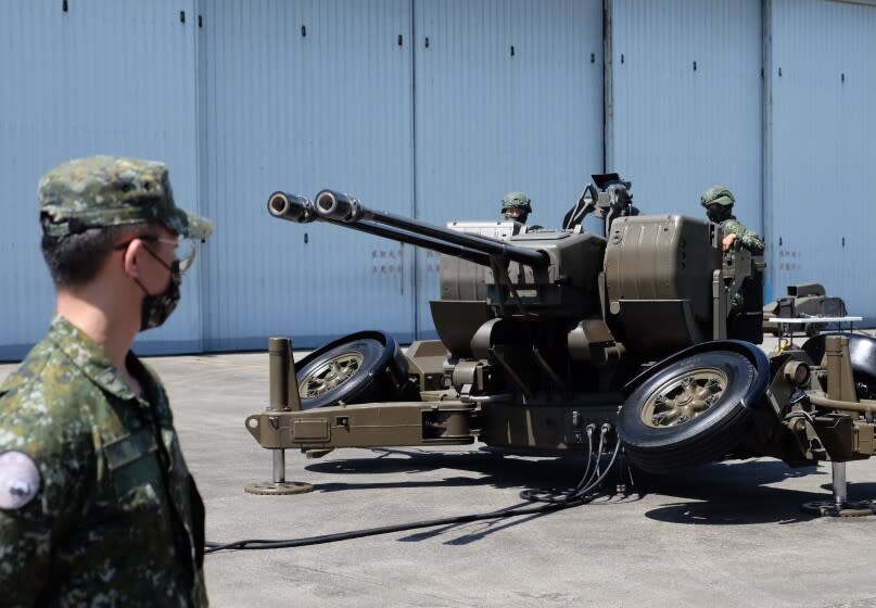 Taiwanese soldiers operate a Oerlikon 35mm twin cannon anti-aircraft gun at a base in Taiwan's southeastern Hualien county on Thursday, Aug. 18, 2022. Taiwan is staging military exercises to show its ability to resist Chinese pressure to accept Beijing's political control over the island.(AP Photo/Johnson Lai)