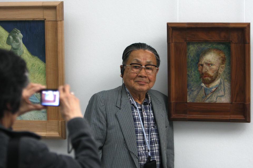 In this photo taken May 8, 2008, a man poses for a portrait next to the 1887 painting "self-portrait" by Vincent van Gogh, at Kroeller-Mueller museum, Otterlo, eastern Netherlands. With the Van Gogh Museum in Amsterdam closed for renovations, the world's second-largest collection of the tortured Dutch master's work is stepping into the limelight. The lesser-known Kroeller-Mueller museum in the eastern Netherlands has revamped the layout of its central rooms, giving more space and focus to many of its top works. (AP Photo/Peter Dejong)