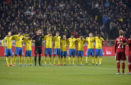 Sweden's soccer players observe a minute of silence to honor the victims in the terror attack in Paris, before the Sweden vs Denmark UEFA Euro 2016 qualifier play-off first leg match at the Friends arena in Stockholm, Sweden, November 14, 2015. REUTERS/Janerik Henriksson/TT News Agency