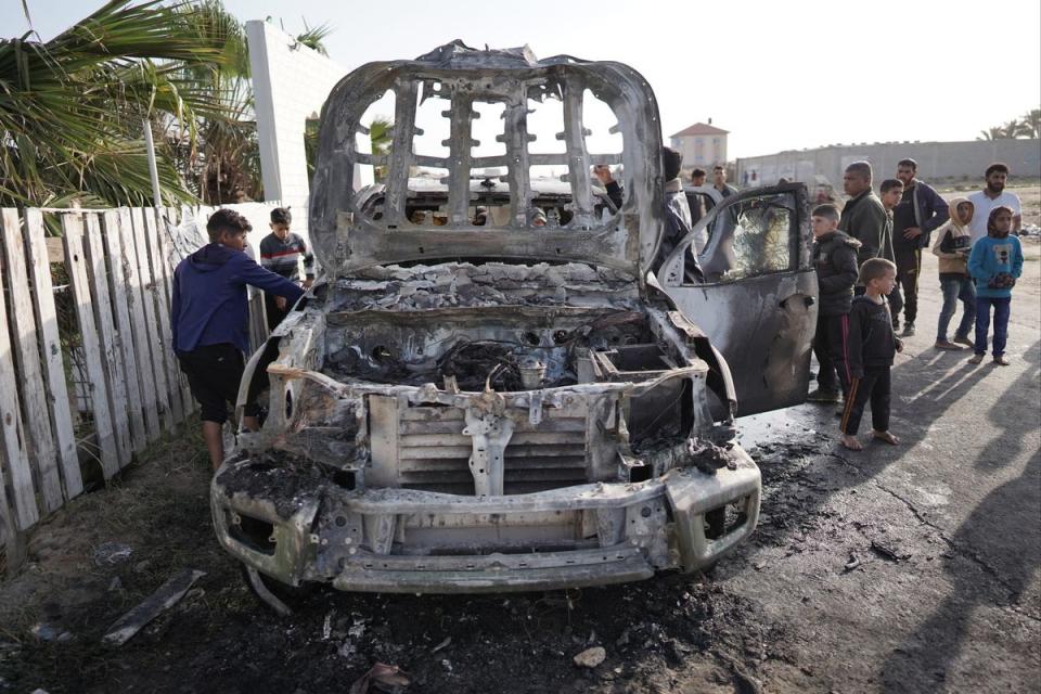 People gather around the WCK car that was hit by Israeli strikes (AFP via Getty Images)