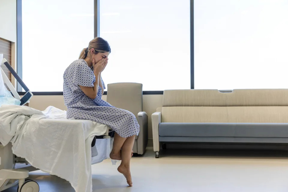 Woman crying in hospital room