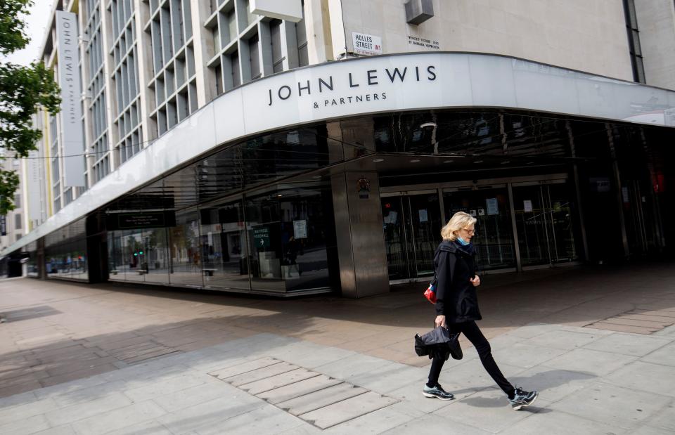 People walk past a John Lewis department store, closed-down due to COVID-19, on Oxford Street in central London on April 27, 2020. - Prime Minister Boris Johnson on Monday made his first public appearance since being hospitalised with coronavirus three weeks ago, saying Britain was beginning to 