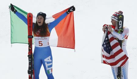 Alpine Skiing - Pyeongchang 2018 Winter Olympics - Women's Downhill - Jeongseon Alpine Centre - Pyeongchang, South Korea - February 21, 2018 - Sofia Goggia of Italy reacts next to Lindsey Vonn of the U.S. during the victory ceremony. REUTERS/Mike Segar