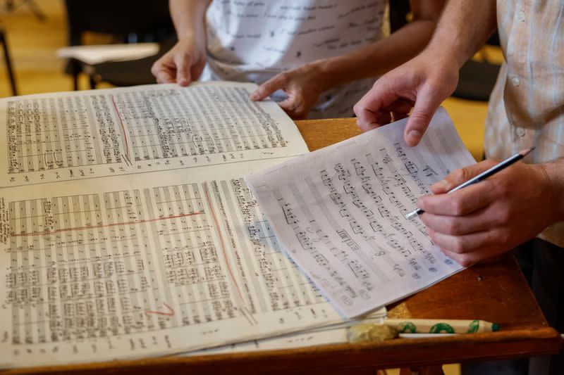 Musicians correct a score of the opera Zorya on a rehearsal before a premiere at the Lviv Organ Hall