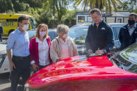 On the hood of an electric car, California Gov. Gavin Newsom signs an executive order requiring all new passenger vehicles sold in the state to be zero-emission by 2035 after a press conference on Wednesday, Sept. 23, 2020, at Cal Expo in Sacramento. It's a move the governor says would achieve a significant reduction in greenhouse gas emissions. California would be the first state with such a rule, though Germany and France are among 15 other countries that have a similar requirement. (Daniel Kim/The Sacramento Bee via AP, Pool)